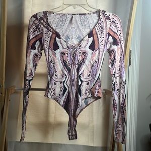 XS Free People body suit with purple designs.
